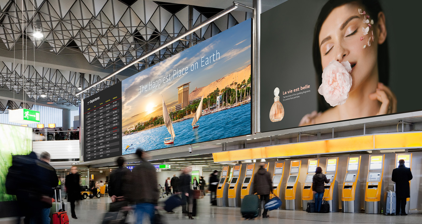 Large LEDs inside an airport show passengers’ departure schedules and advertisements.