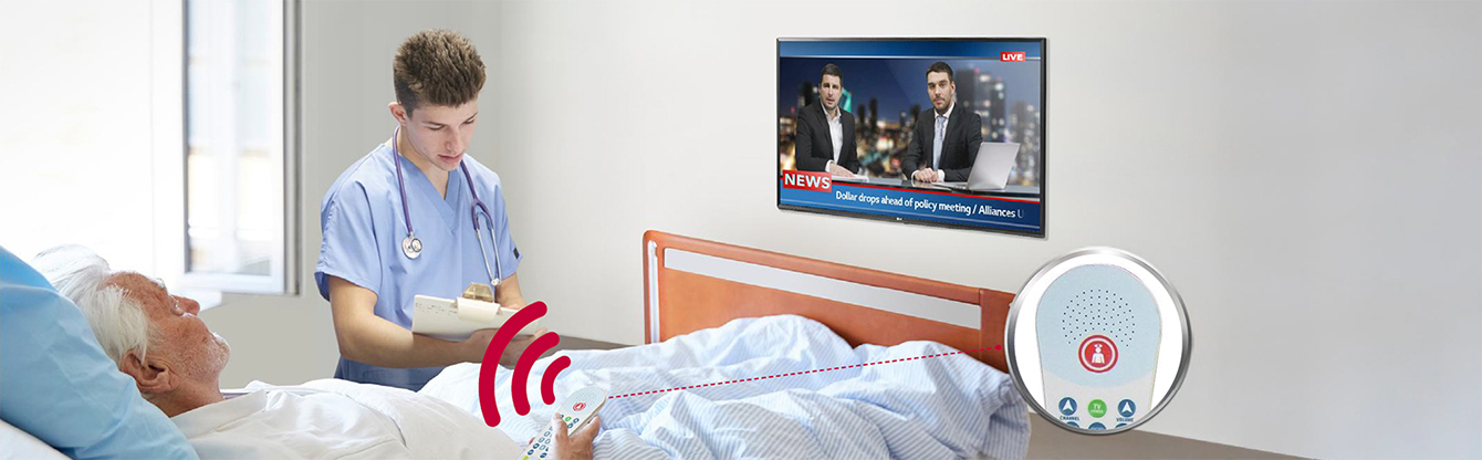 A patient lying in the bed is controlling the TV through a pillow speaker connected to the LN662M.