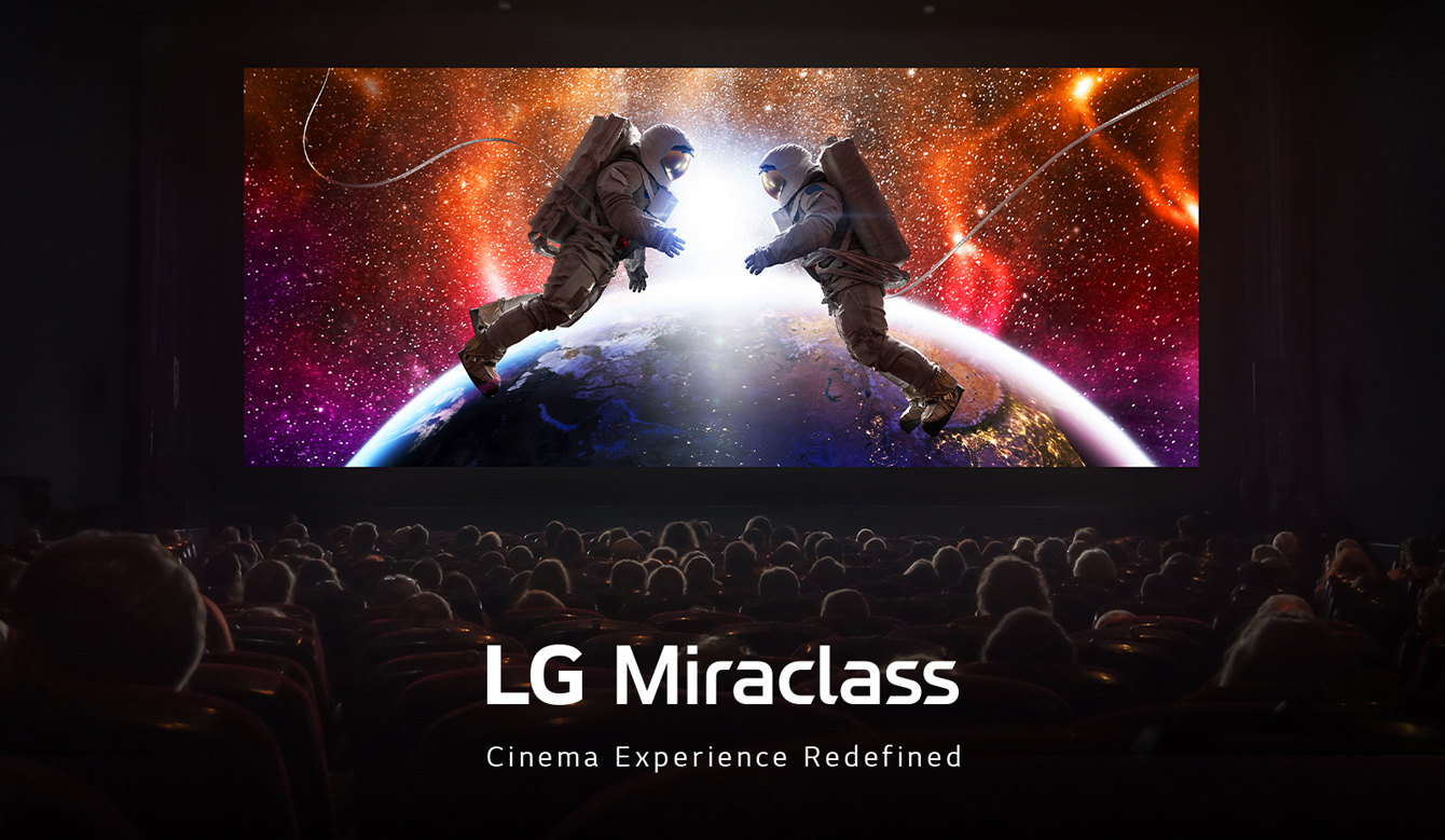 A large LED screen is showing a colorful and lively outer space scene at a movie theater.