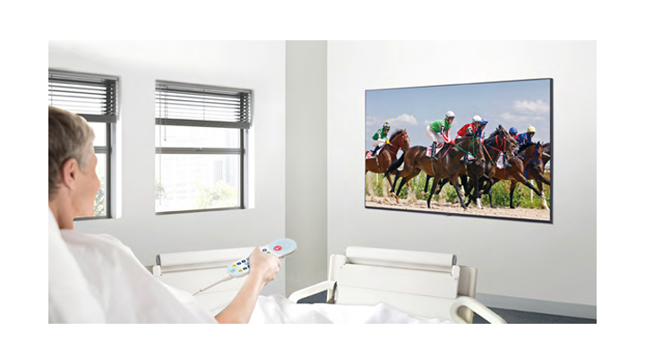 A patient in the hospital room is watching VOD on a TV hanging on the wall without a set-top box.