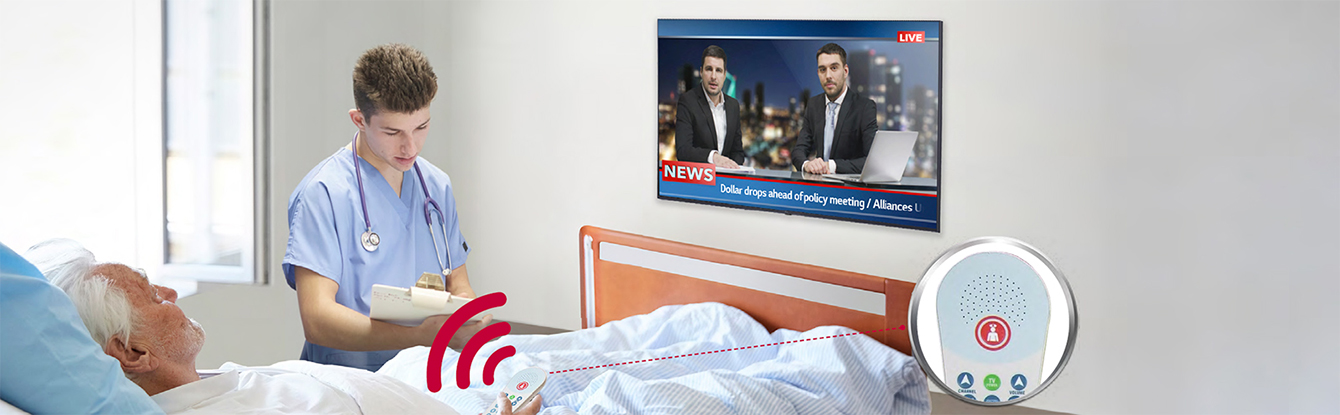 A patient lying in the bed is watching TV while listening to it through a pillow speaker.