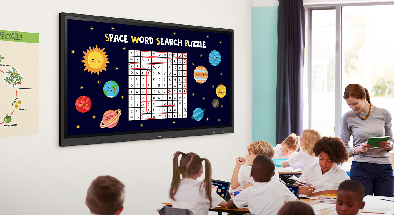 Class is being conducted in the classroom, and the class material screen which is displayed on the classroom wall's LG CreateBoard is being shared on the students' tablets.
