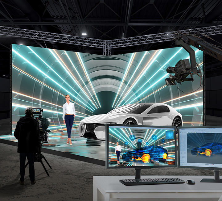 Filming of the model and car is taking place in a virtual production studio that features cube-shaped wall-mounted, ceiling, and floor LED displays. While only the model and car are physically present, the monitor displays AR effects, such as 3D rendering of the car, for verification purposes.