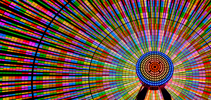 The Ferris wheel shines brightly with vibrant colors.