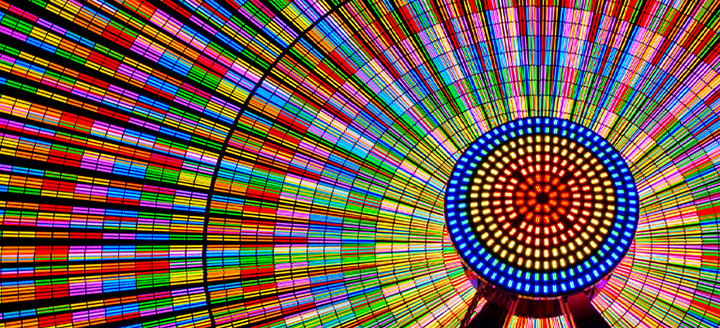 The Ferris wheel shines brightly with vibrant colors.