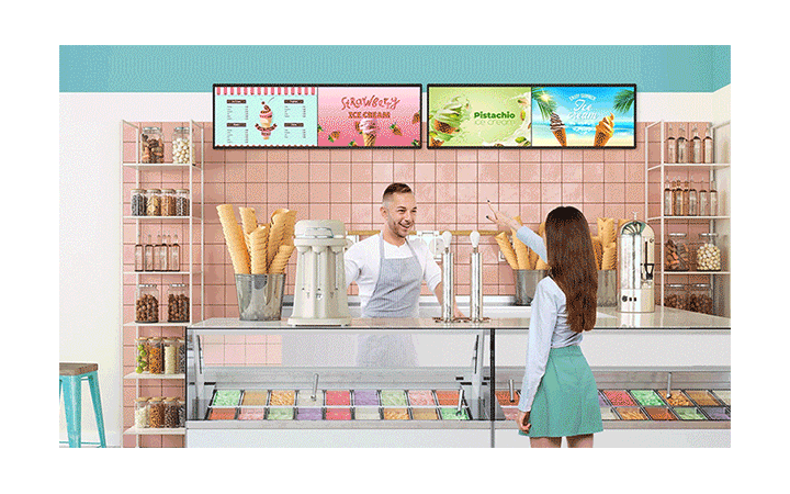 Inside an ice cream shop, there is a BH7N installed, and the screen is simultaneously showing the ice cream menu and advertisements.