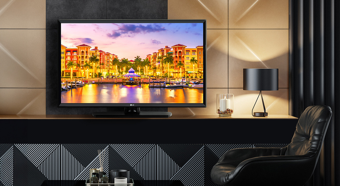 A TV is installed in the hotel room, and a vivid sunset scenery is displayed on the screen.