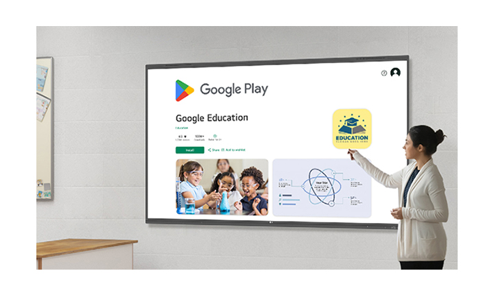 A woman is using LG CreateBoard to browse the Google Play Store, downloading educational apps.