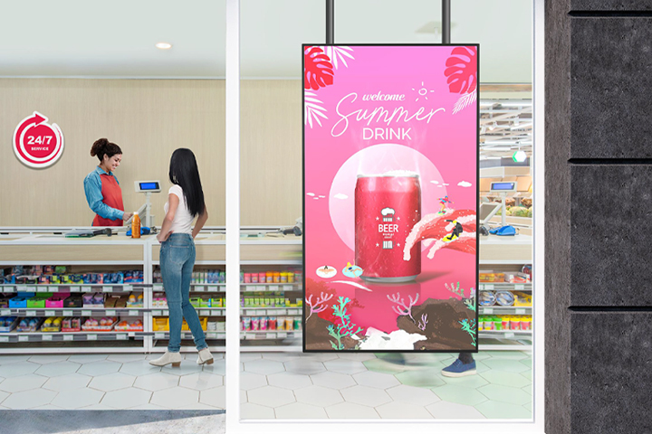 A large LED display is installed on the window inside the convenience store, vividly and brightly showcasing advertisements through the glass.