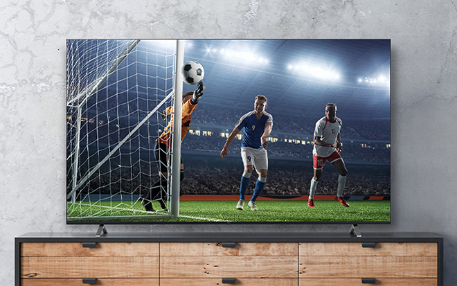 The soccer game scene shown on the TV screen appears real.