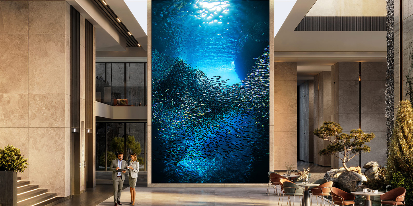 A large, majestic LG MAGNIT is installed in the company lobby, with vibrant underwater landscapes clearly visible on the screen.