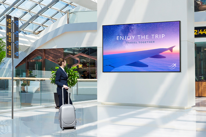 The display has been installed on a column at the airport, which is exposed to bright sunlight. Despite the bright environment, advertisements on the display are clearly visible.