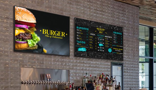 Two UV5N-E units powered by BrightSignOS are installed on the wall of a restaurant.