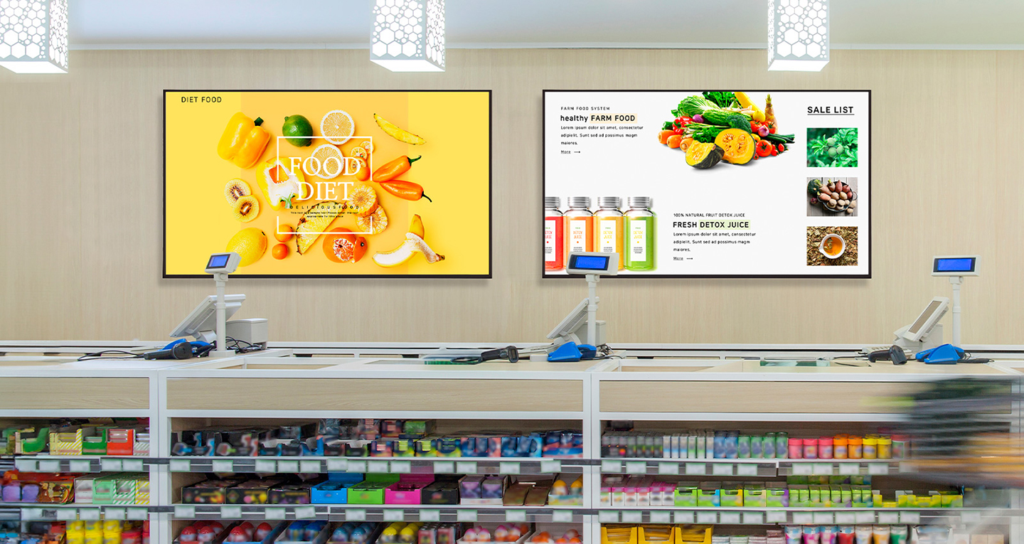 Inside the convenience store, two signage displays are mounted on the wall, each vividly and brightly showcasing advertisements.