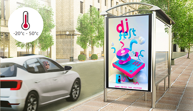 A woman in a car is looking at a DOOH (Digital Out Of Home media) advertisement on the side of the road. This display can operate within a wide temperature range of -20℃ to 50℃.