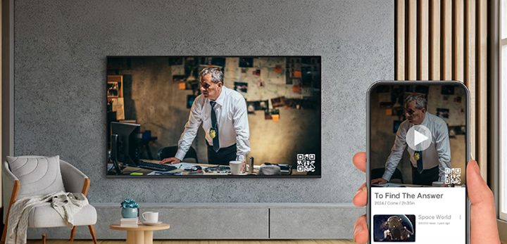 A hotel guest is using OTT services by pairing their smartphone with the in-room TV through QR code login.